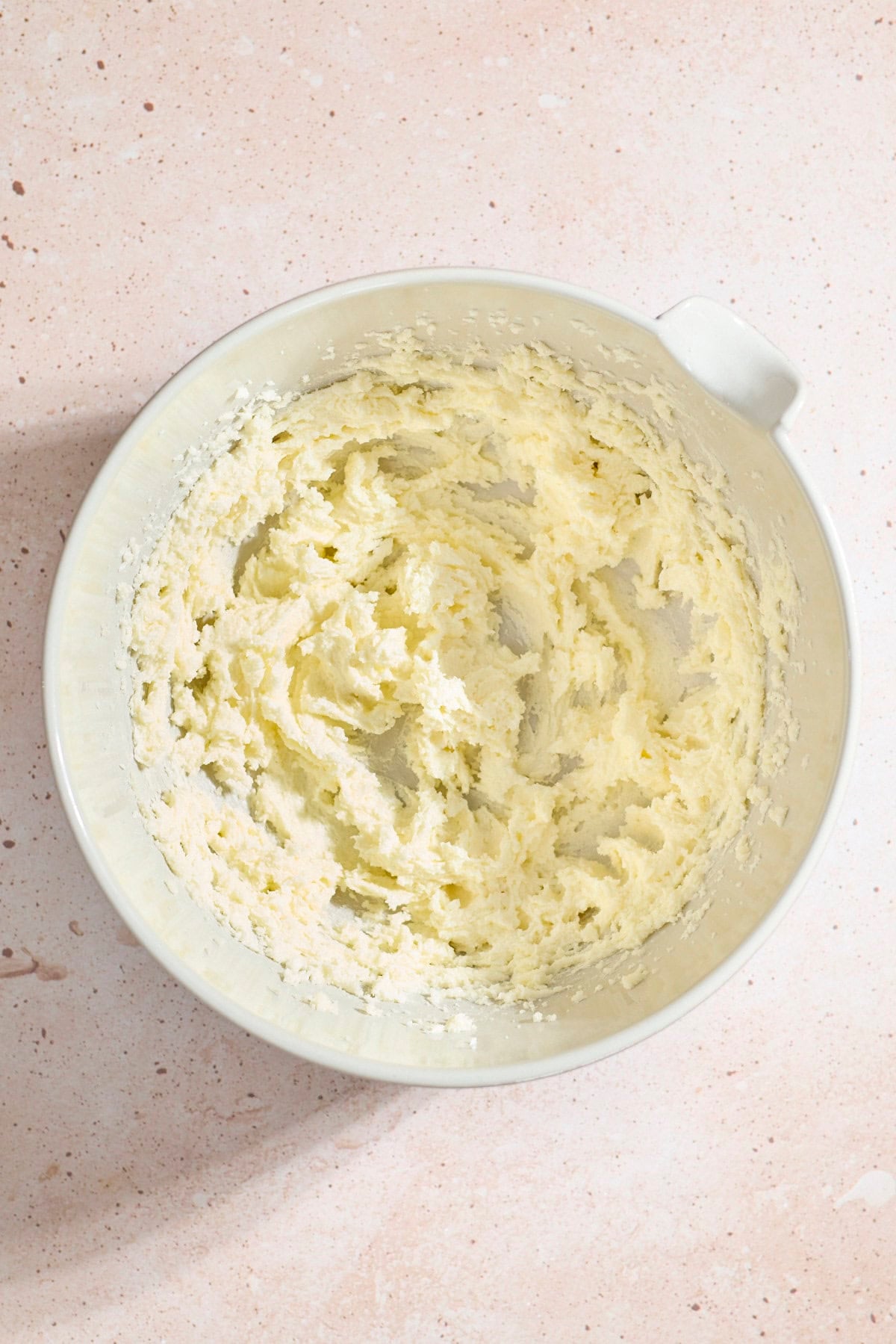 Butter and sugar creamed in a large mixing bowl.
