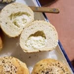 A Sourdough Discard Stuffed Bagel cut in half to show the cream cheese.