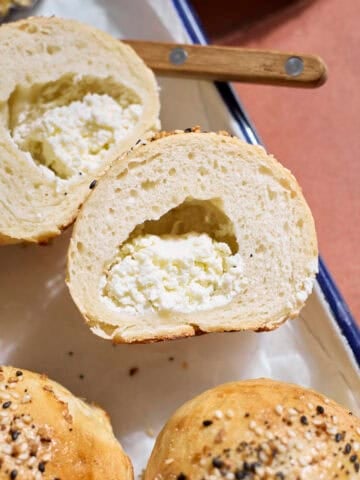 A Sourdough Discard Stuffed Bagel cut in half to show the cream cheese.