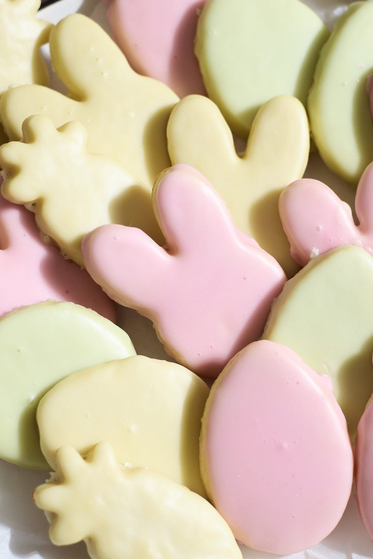 Iced cookies in a variety of colors on a platter.