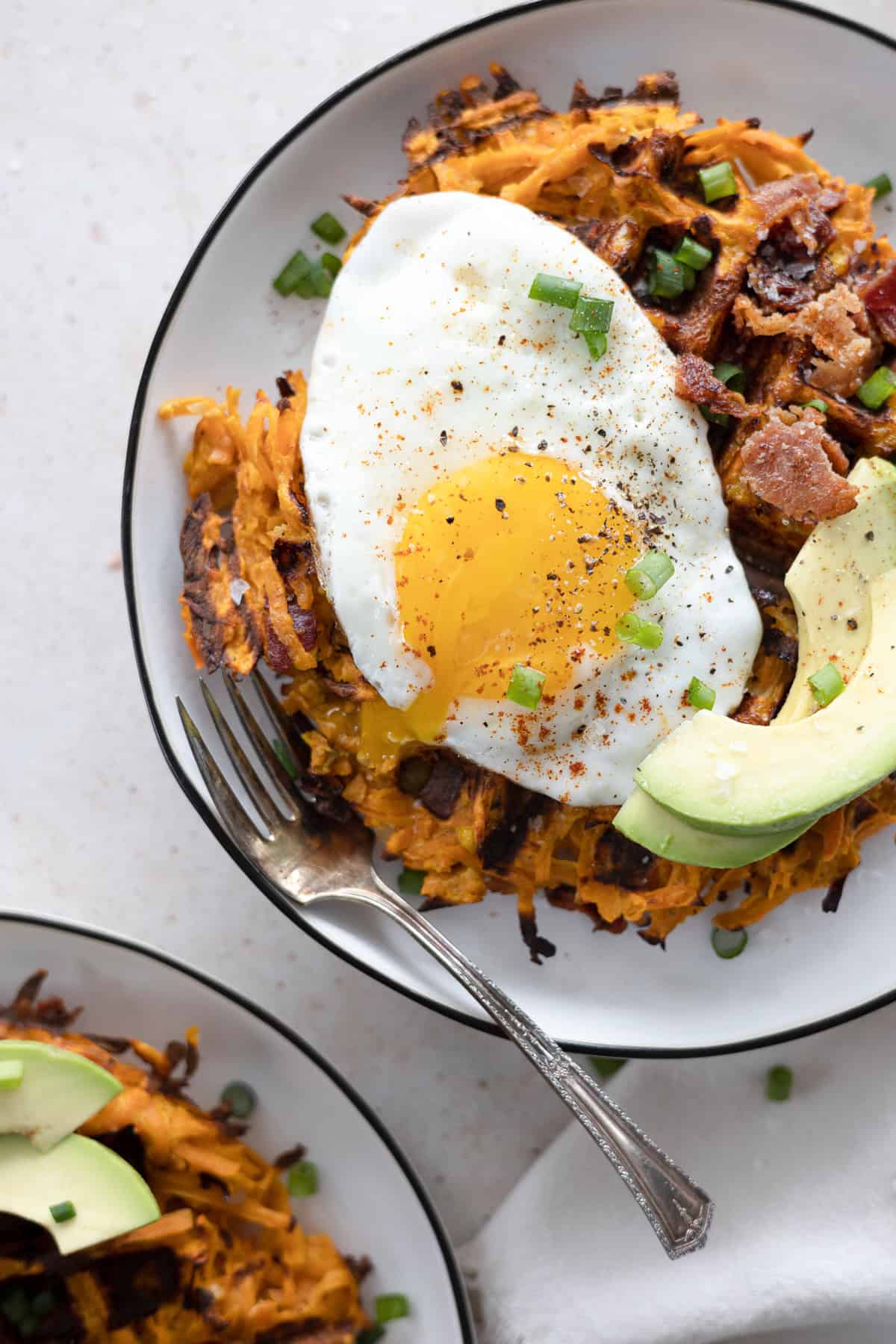 Savory Sweet Potato Waffles topped with egg and avocado.