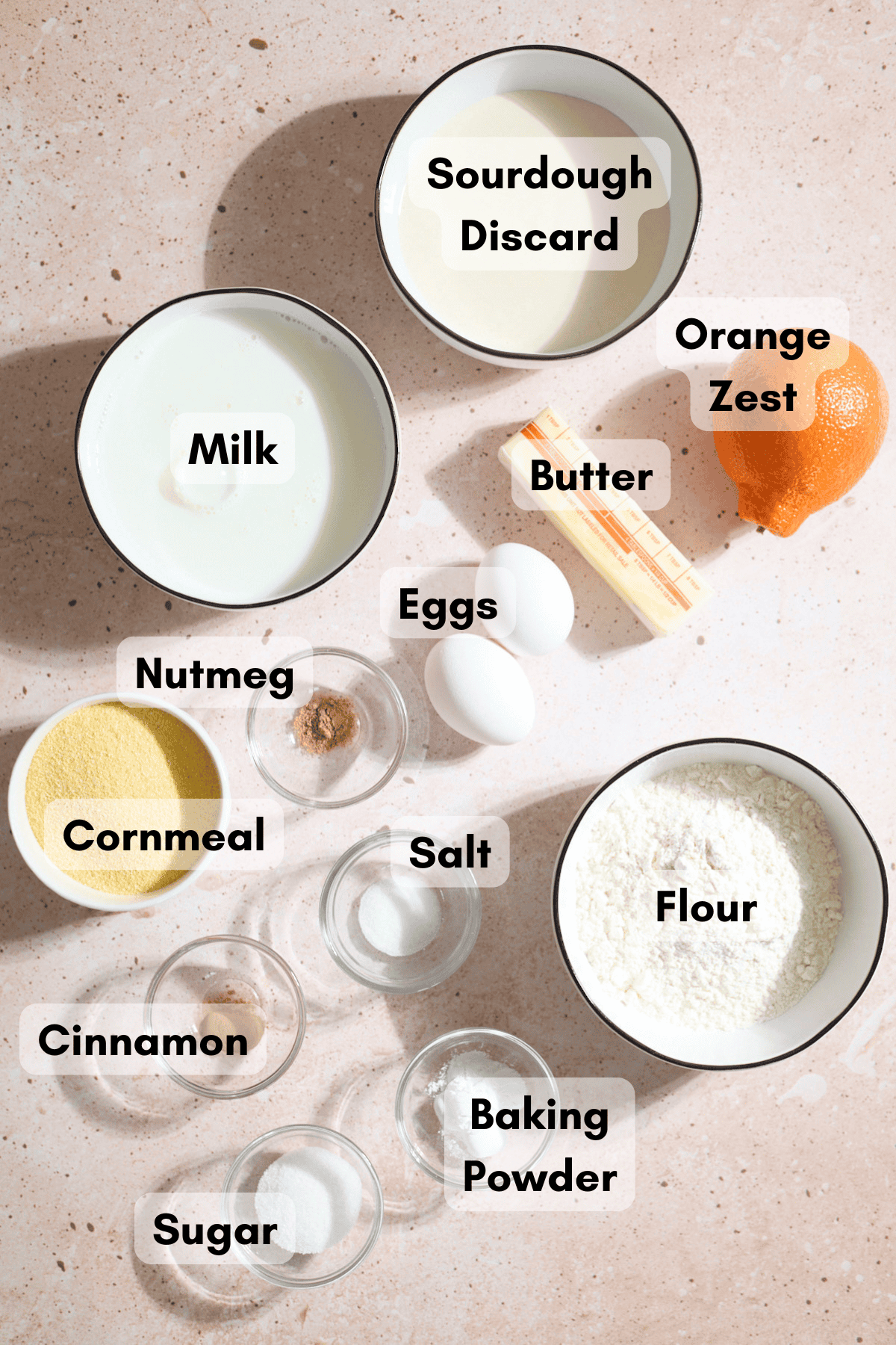 Ingredients for Sourdough Cornmeal Waffles in small bowls.