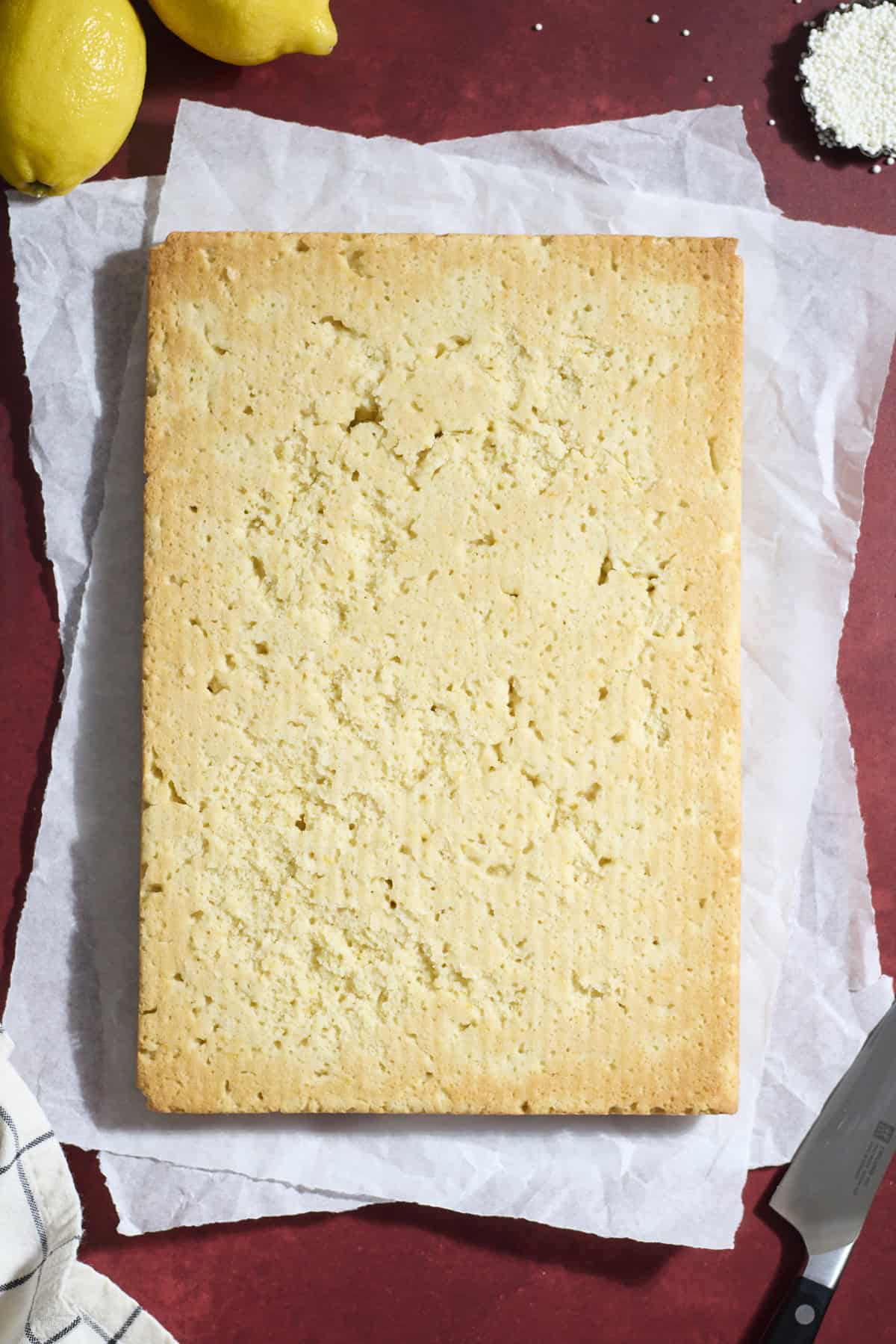 Baked cookie bars on white parchment paper.