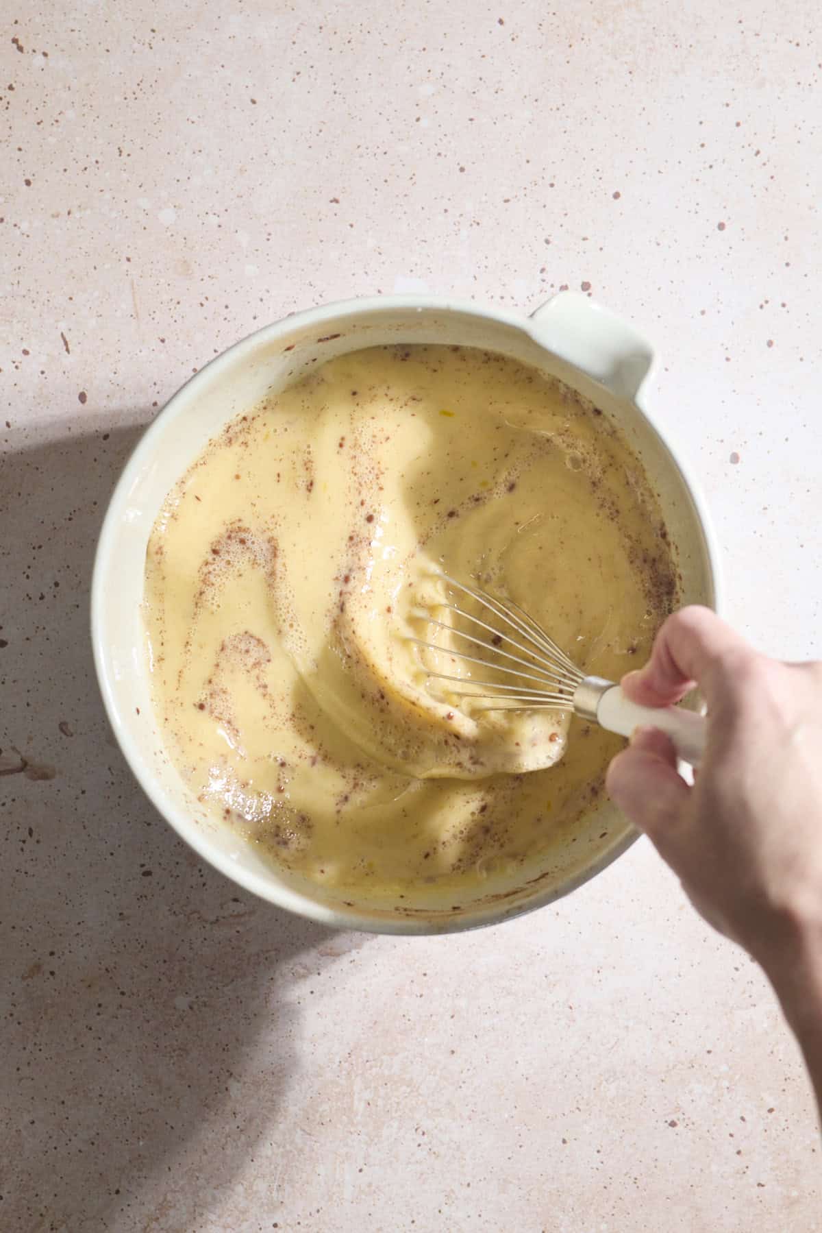 Egg mixture being whisked in a bowl.
