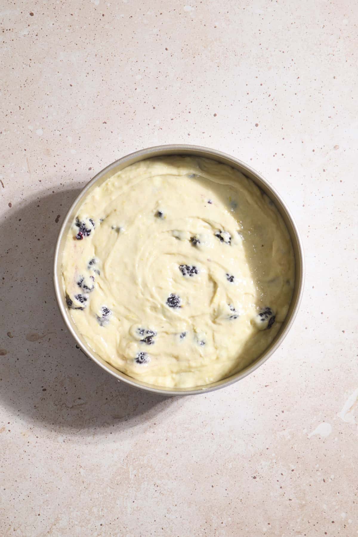 Cake batter spread into the baking pan.