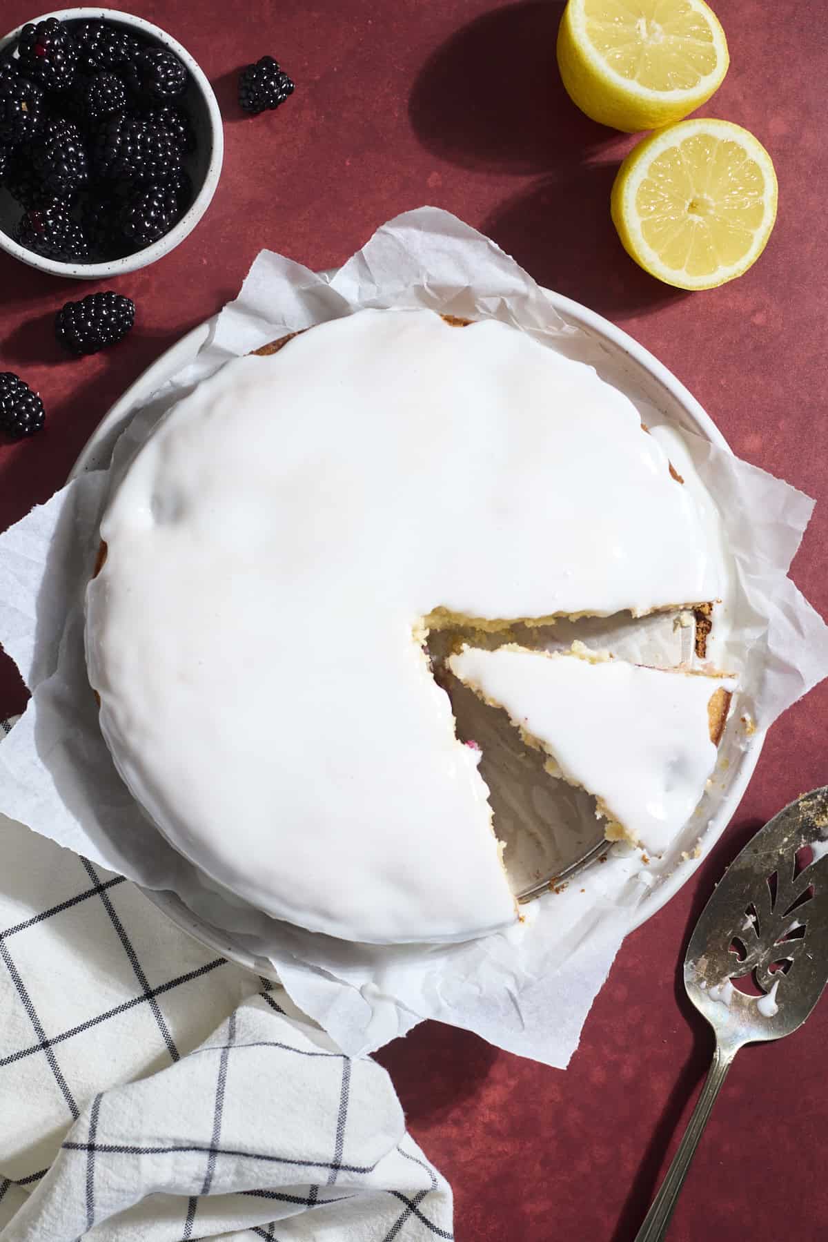 Cake with glaze on top and one slice cut out.