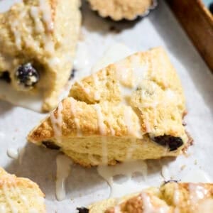 Sourdough Lemon Blueberry Scones on white parchment paper.