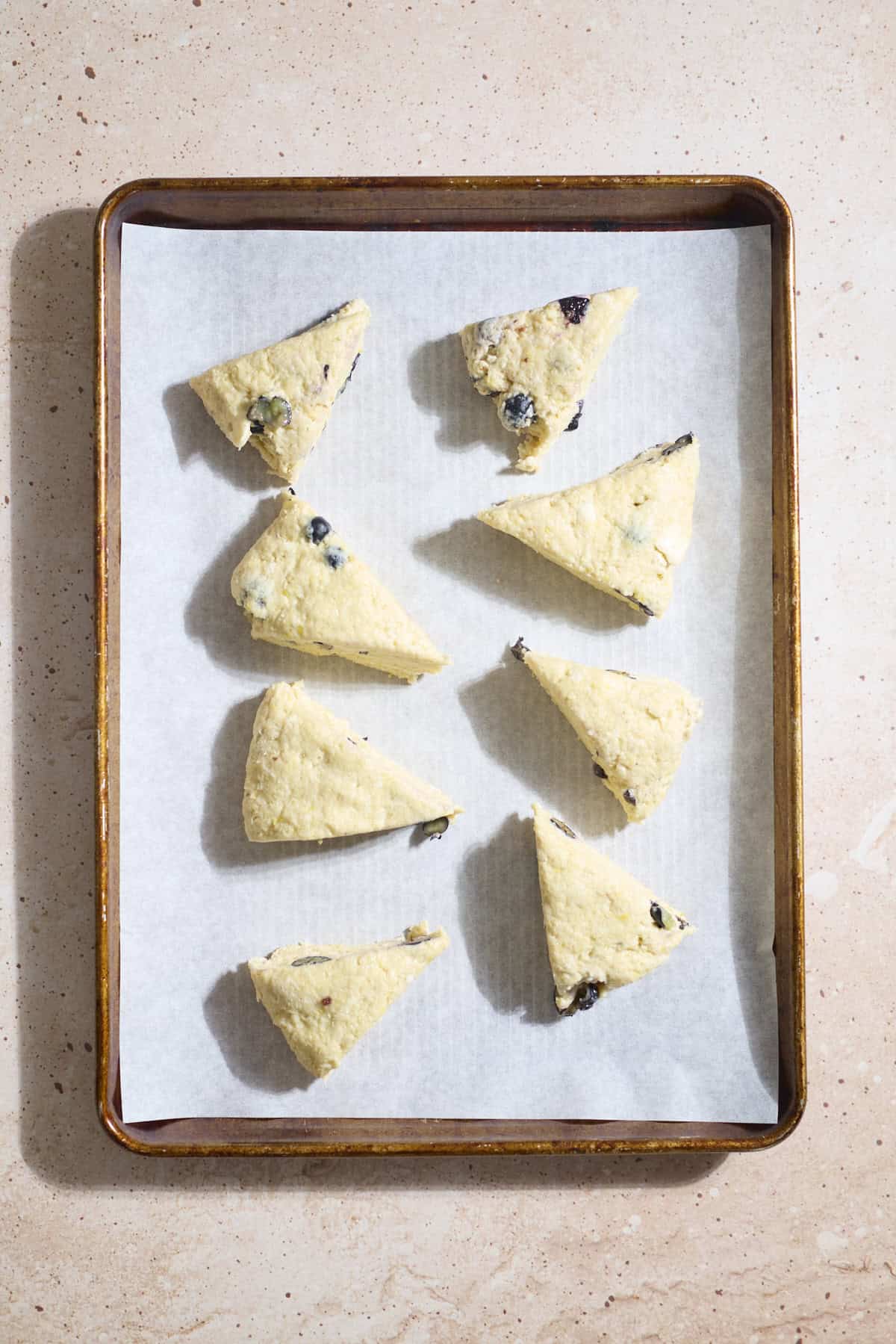 Cut scones on a baking sheet.