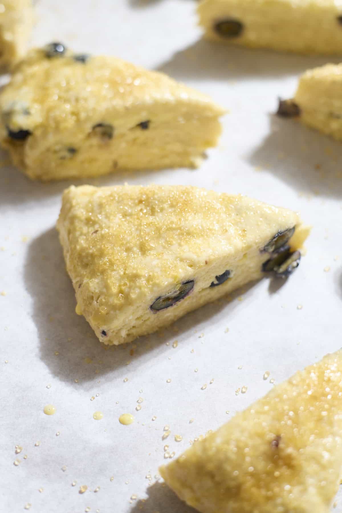 Scones brushed with egg wash and sprinkled with turbinado sugar.