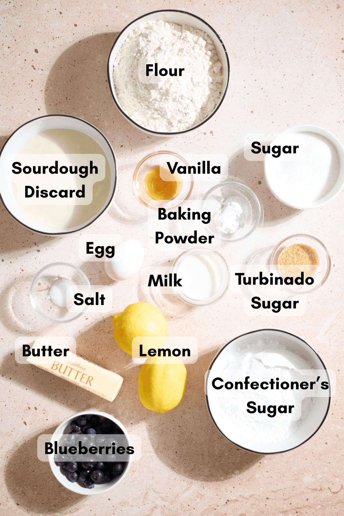Ingredients for Sourdough Lemon Blueberry Scones in small bowls.