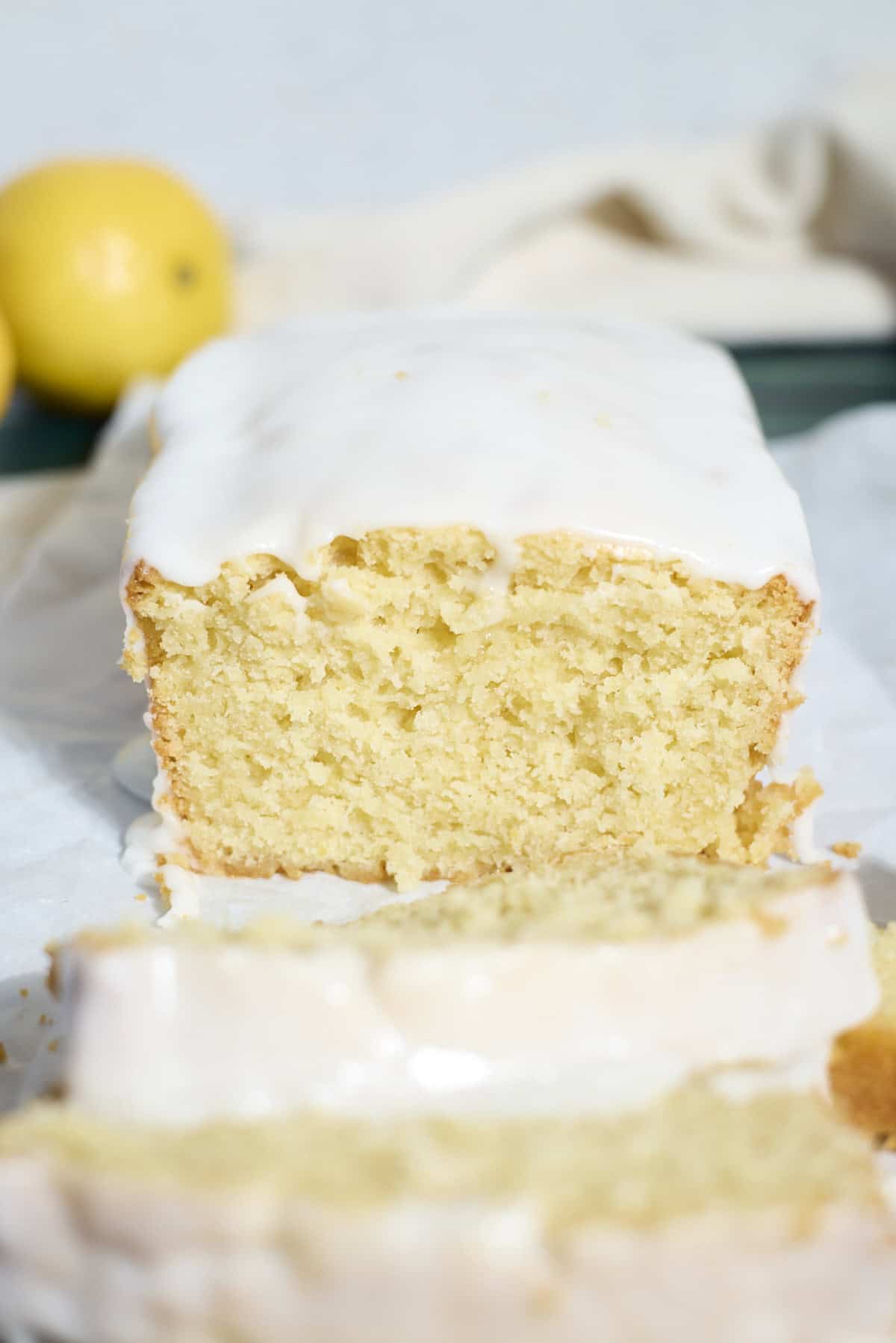 A side view of the sliced Sourdough Lemon Loaf Cake.