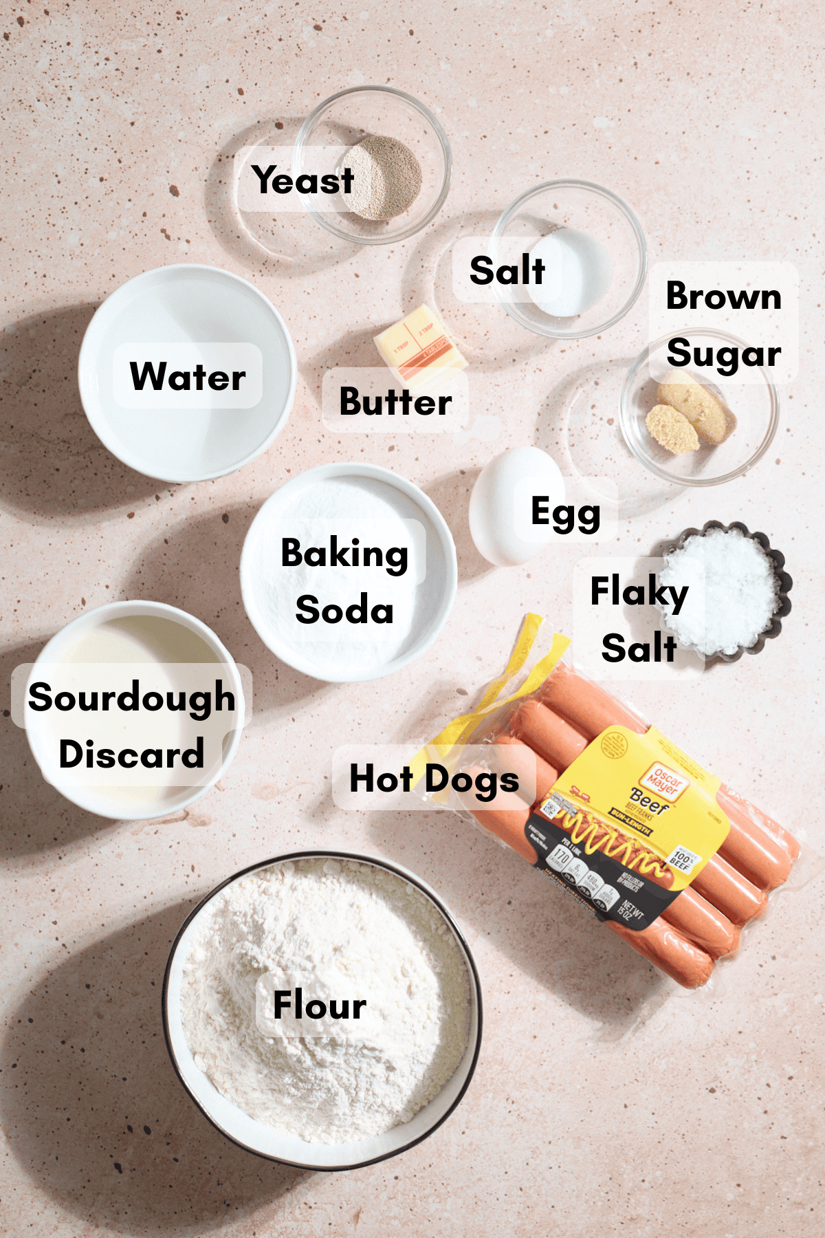 Ingredients for Sourdough Discard Pretzel-Wrapped Hot Dogs in small bowls.