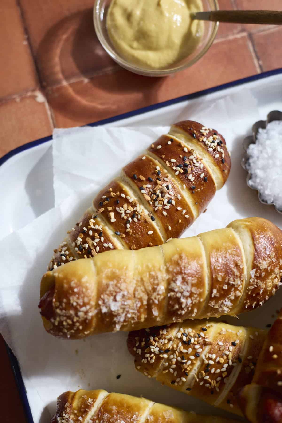 Sourdough Discard Pretzel-Wrapped Hot Dogs on a white tray.