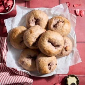 Sourdough Discard Strawberry Bagels on a white platter.