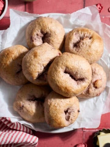 Sourdough Discard Strawberry Bagels on a white platter.