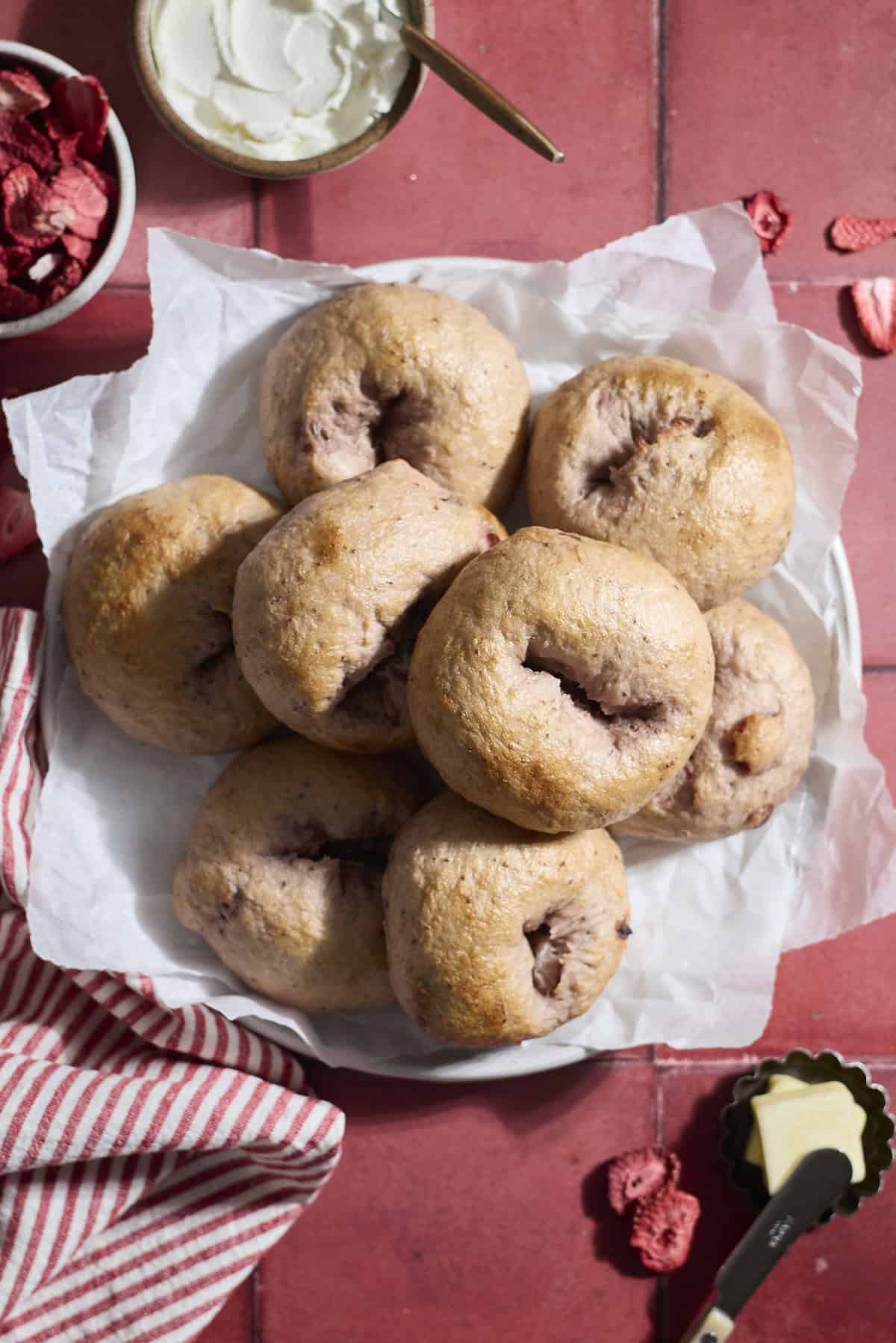 Sourdough Discard Strawberry Bagels on a white platter.