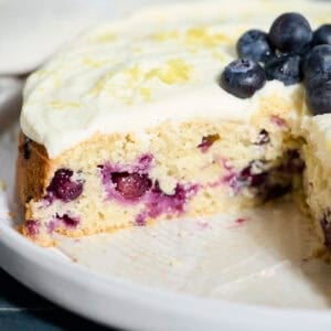 Blueberries in a slice of Sourdough Lemon Blueberry Cake.