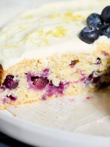 Blueberries in a slice of Sourdough Lemon Blueberry Cake.