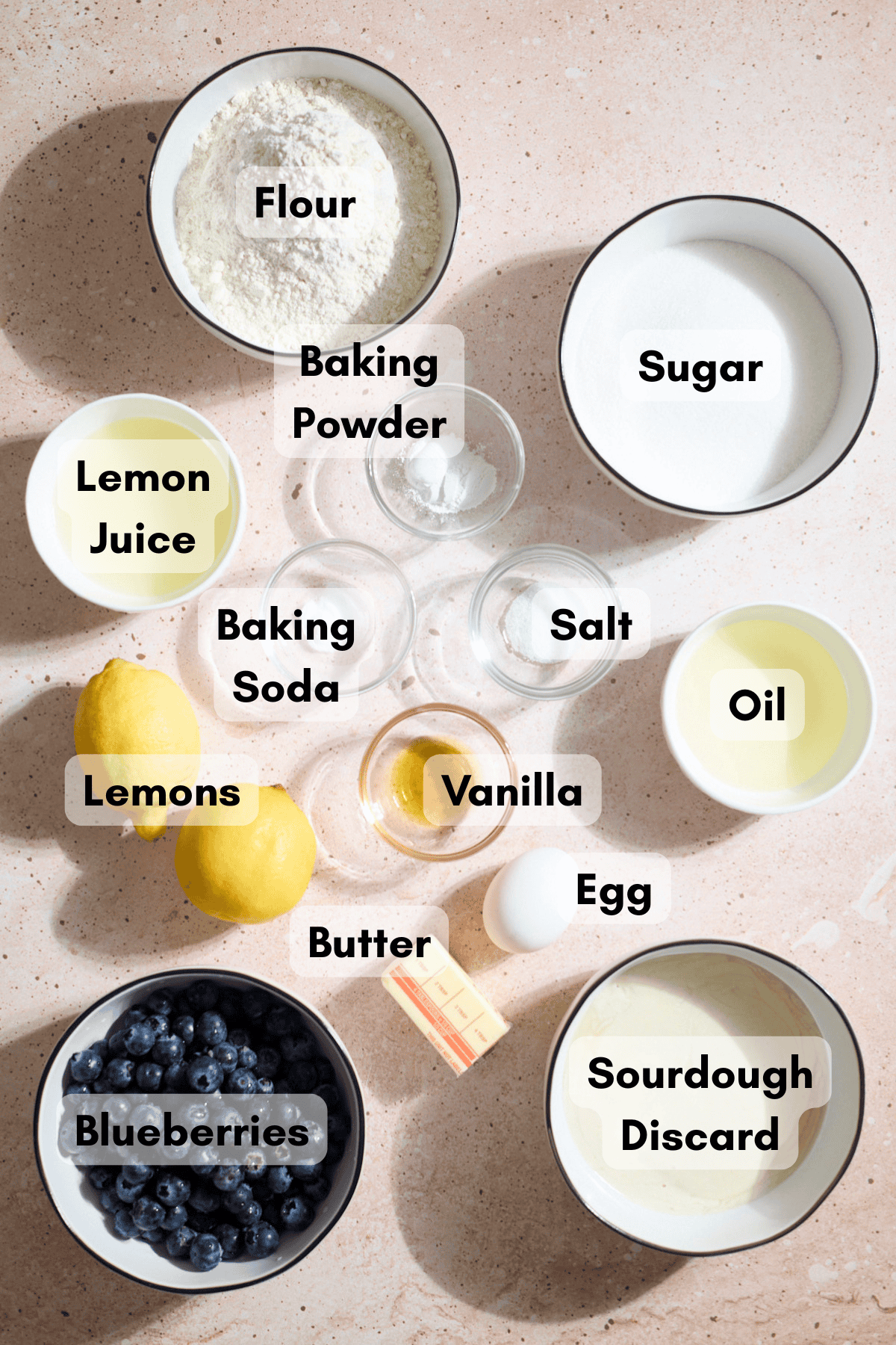 Ingredients for Sourdough Lemon Blueberry Cake in small bowls.
