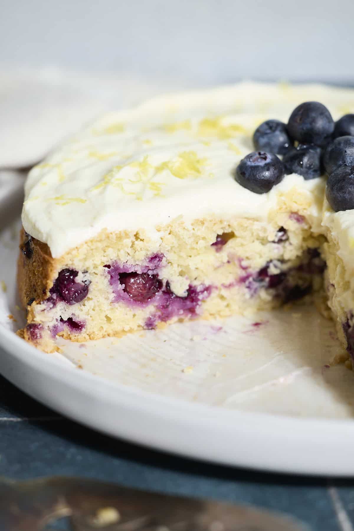 Blueberries in a slice of Sourdough Lemon Blueberry Cake.