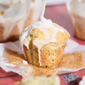 Sourdough Lemon Poppy Seed Muffins drizzled with glaze.