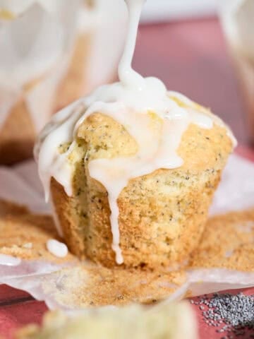 Sourdough Lemon Poppy Seed Muffins drizzled with glaze.