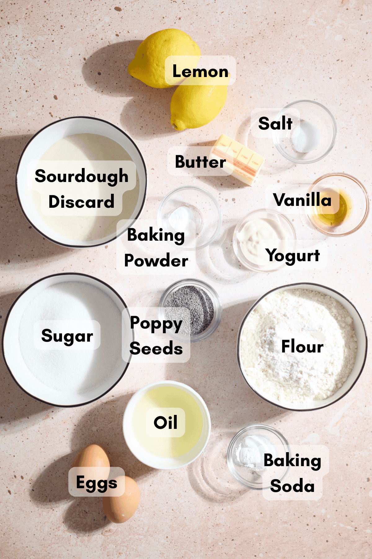 Ingredients for Sourdough Lemon Poppy Seed Muffins in small bowls.