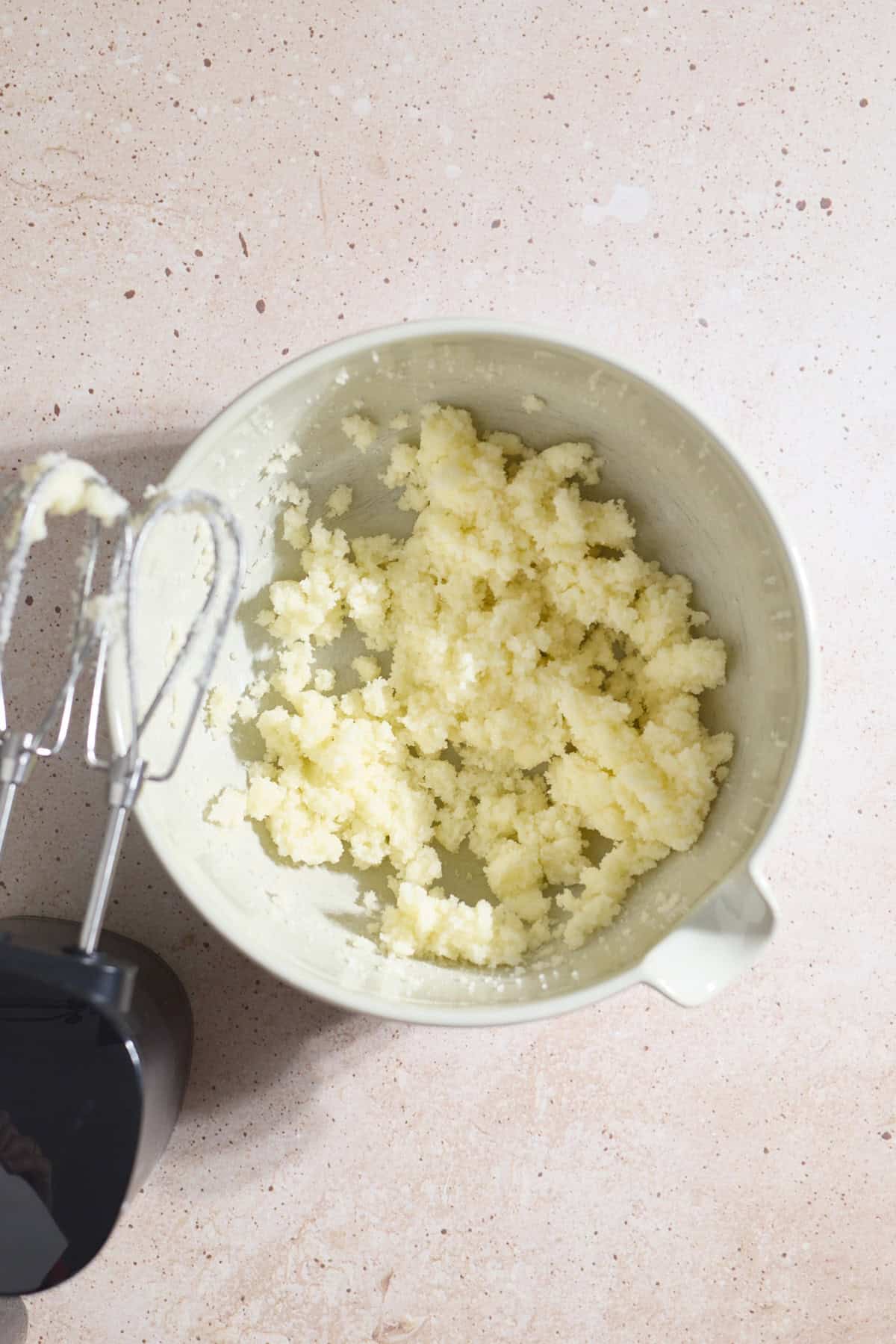 Butter and sugar creamed in a mixing bowl.