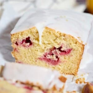 A slice of Sourdough Lemon Raspberry Loaf Cake.