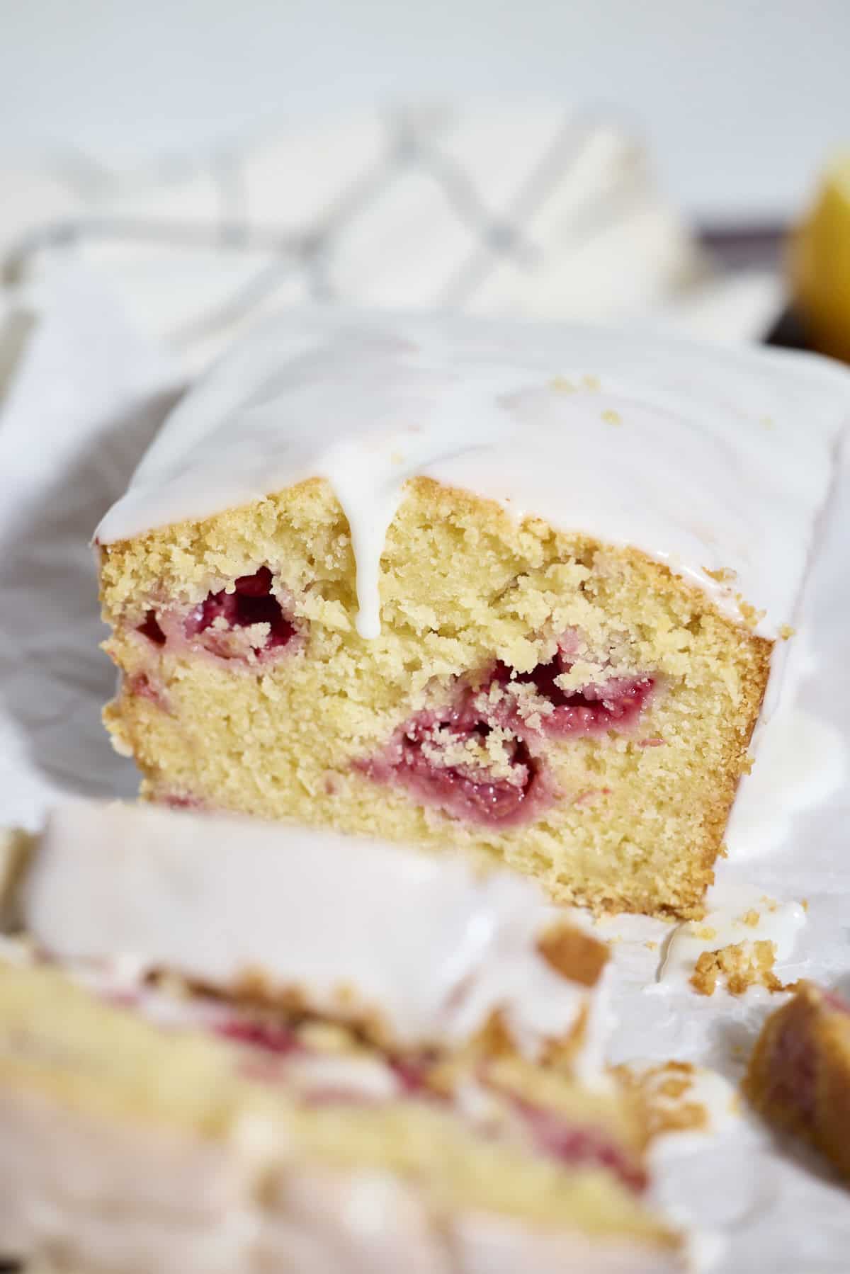 A slice of Sourdough Lemon Raspberry Loaf Cake.