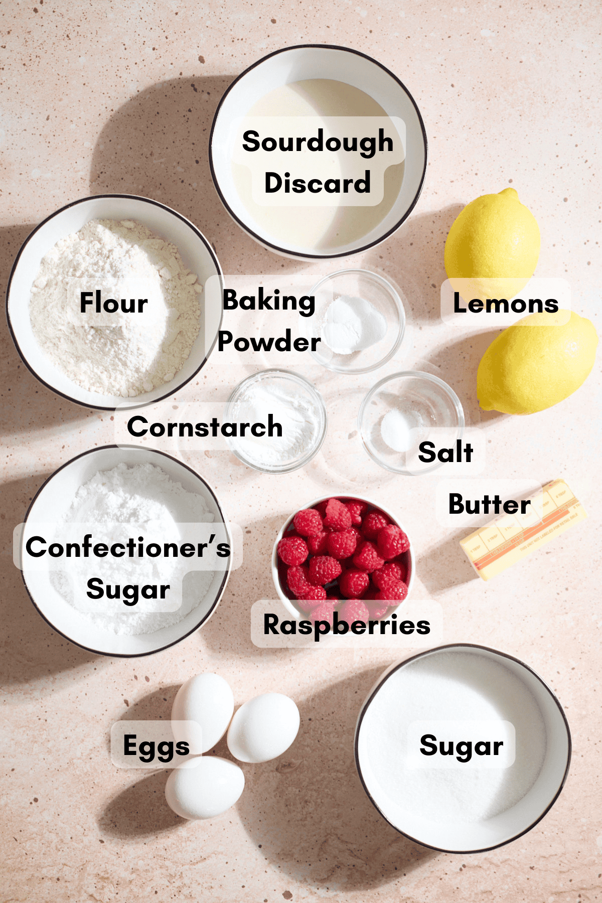 Ingredients for Sourdough Lemon Raspberry Loaf Cake in small bowls.