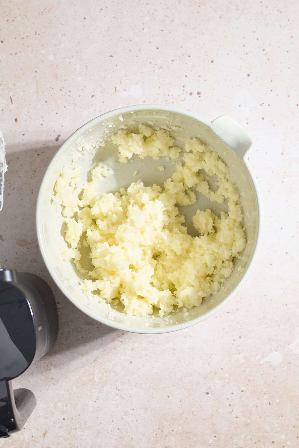Butter and sugar creamed in a large mixing bowl.
