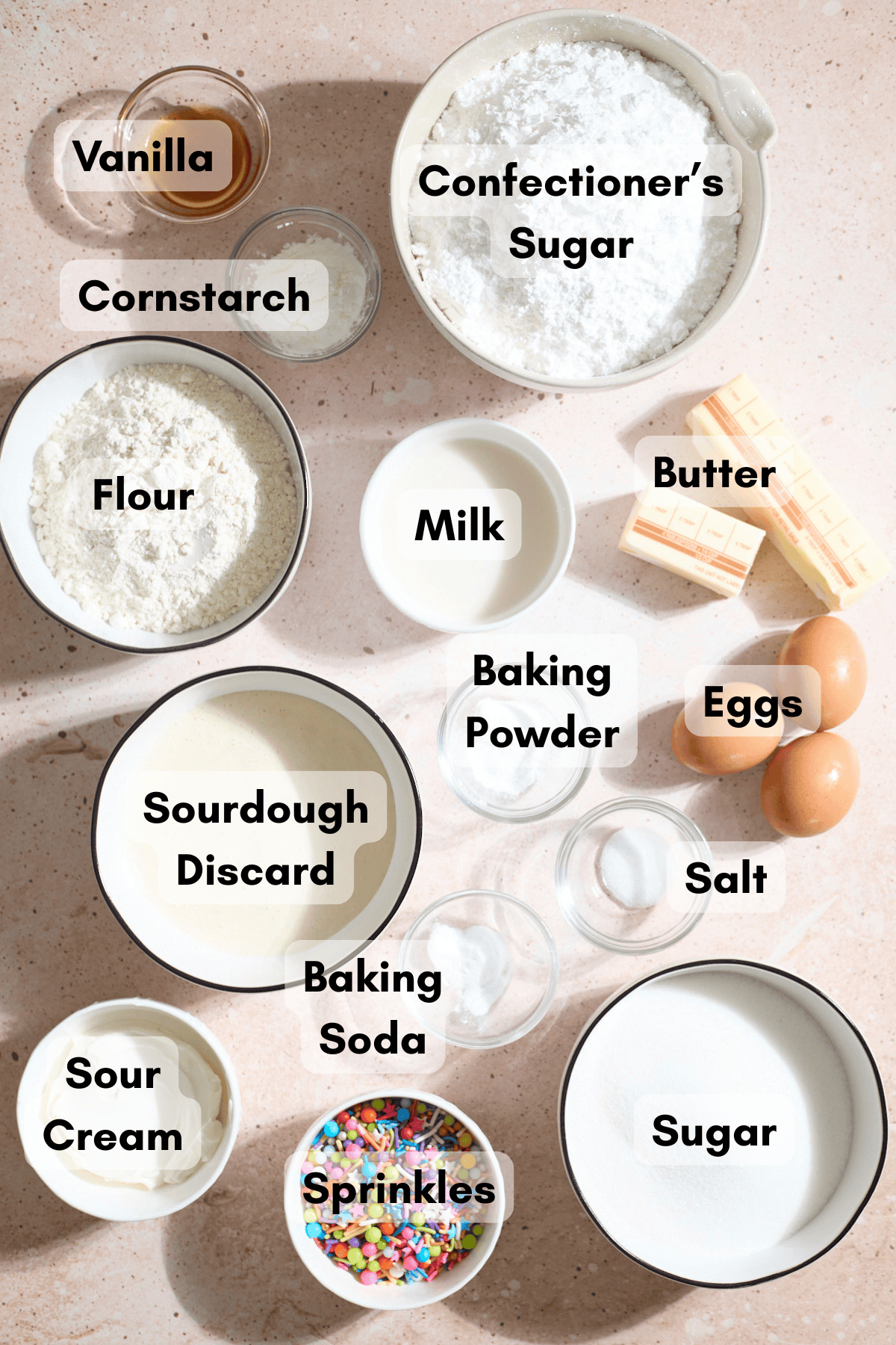 Ingredients for Sourdough Vanilla Cupcakes in small bowls.