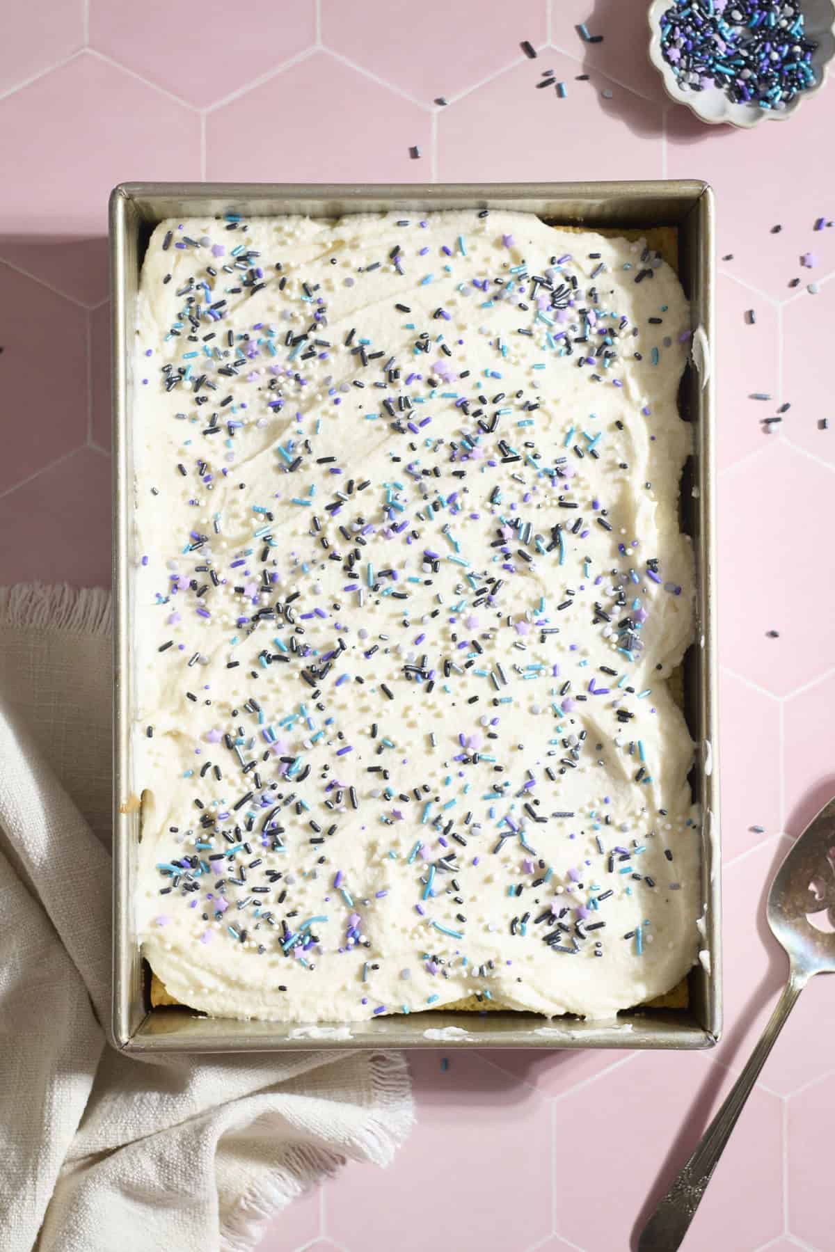 Sheet cake topped with frosting and sprinkles.