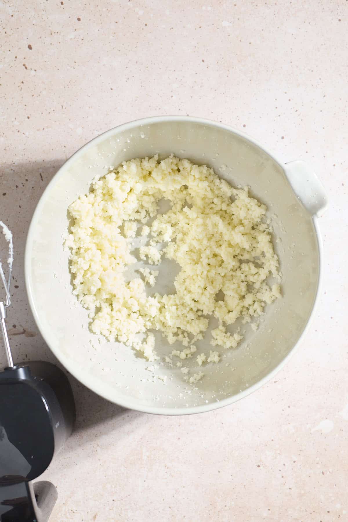 Butter and sugar creamed in a large mixing bowl.
