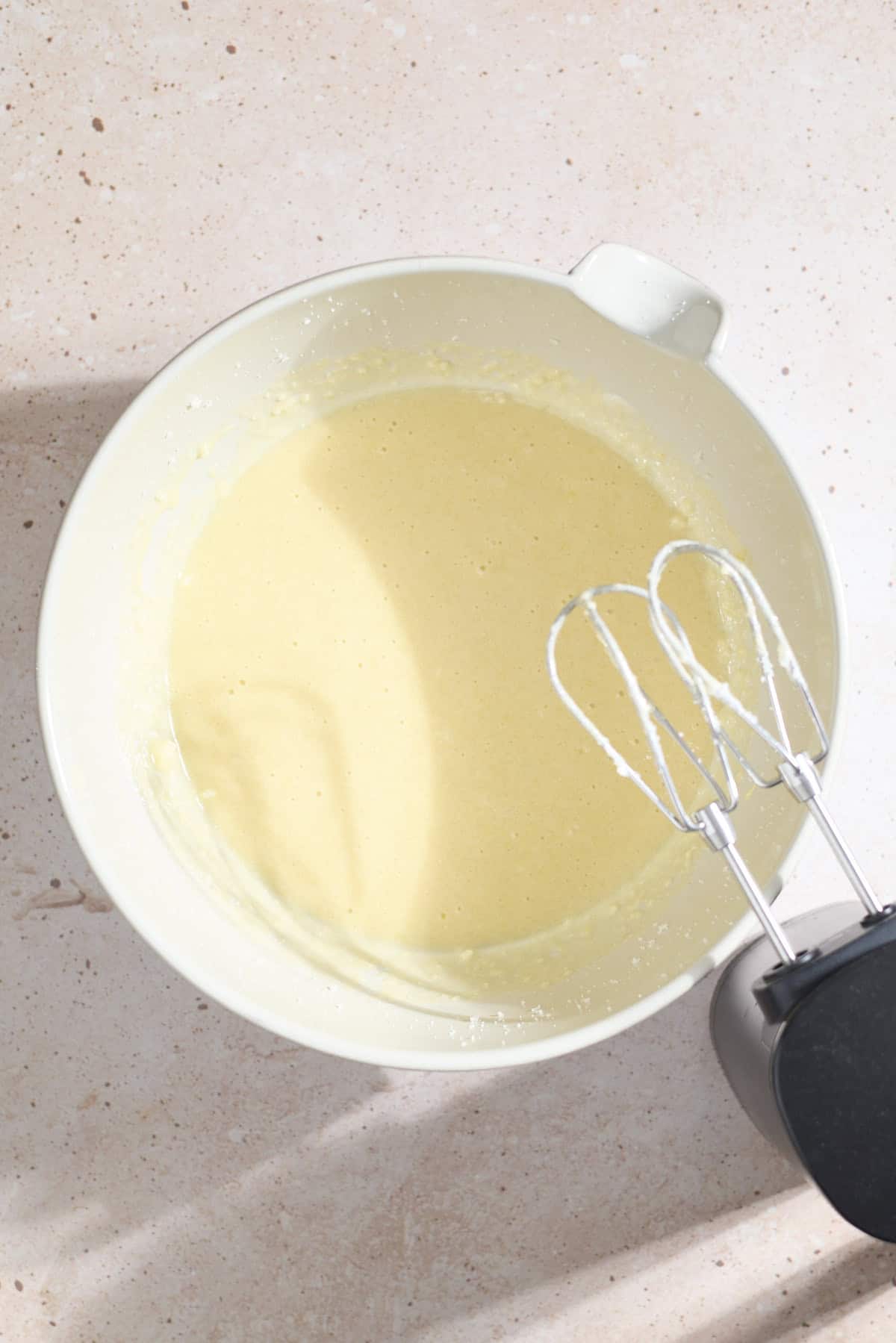 Wet ingredients mixed in a large mixing bowl.