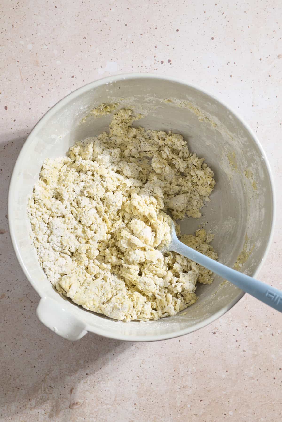Dough coming together in a large mixing bowl.