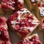 Slices of Sourdough Strawberry Donut Focaccia with icing drizzled on top.