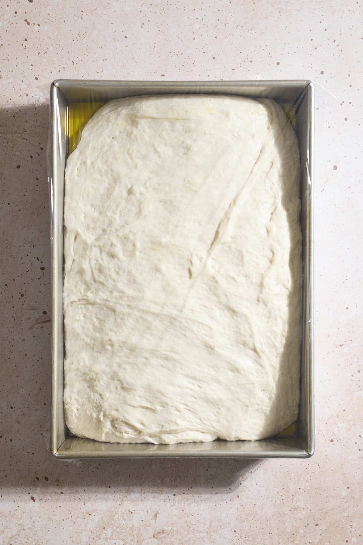 Dough spread to the edges of the baking pan.
