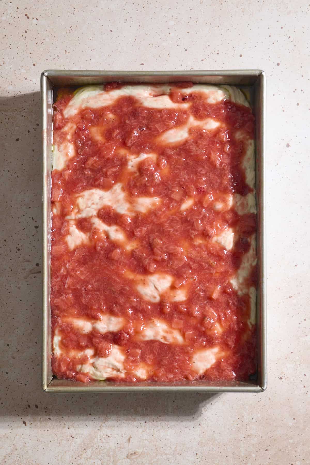 Strawberry jam mixture spread on top of the dough.