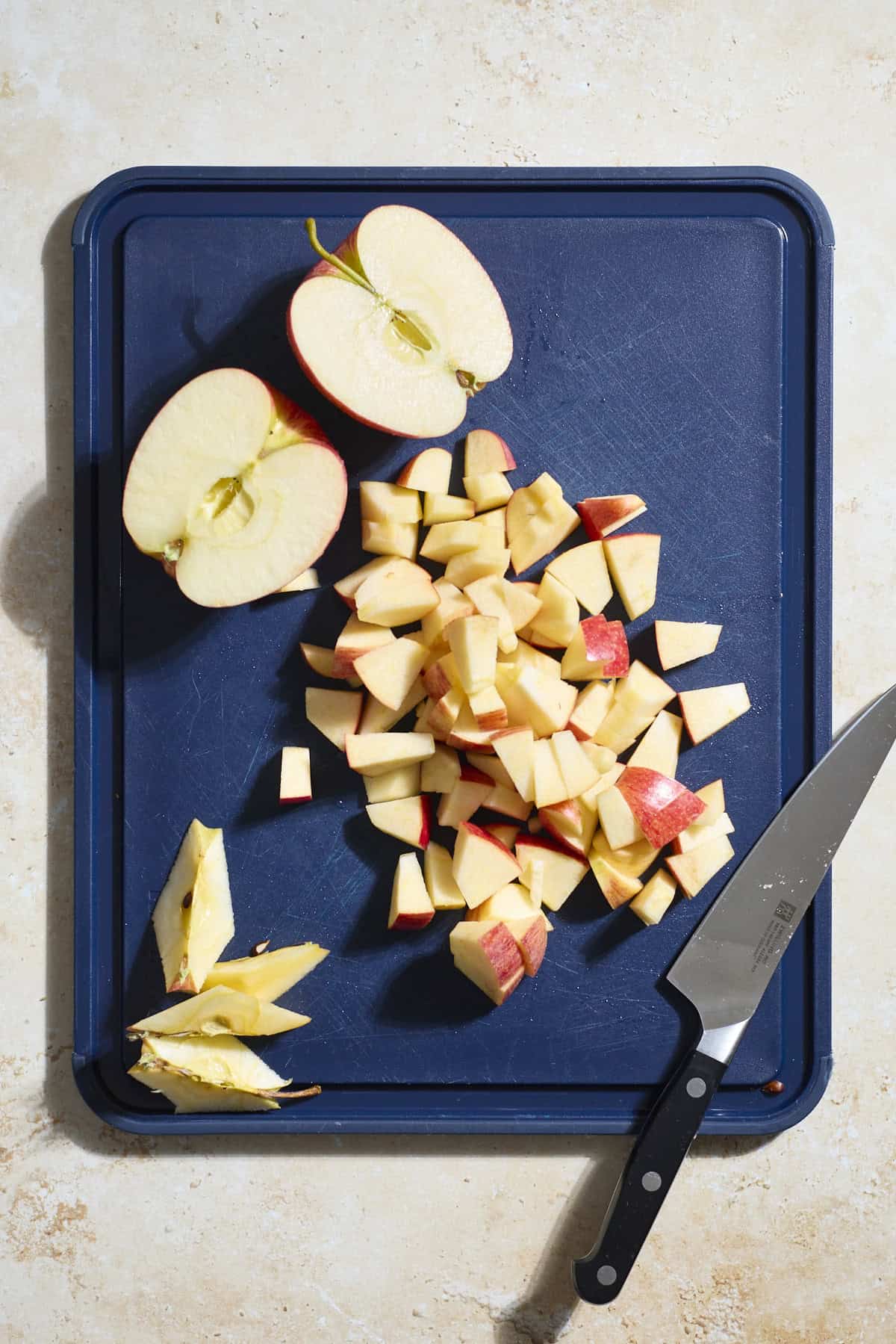 Diced apples on a cutting board.