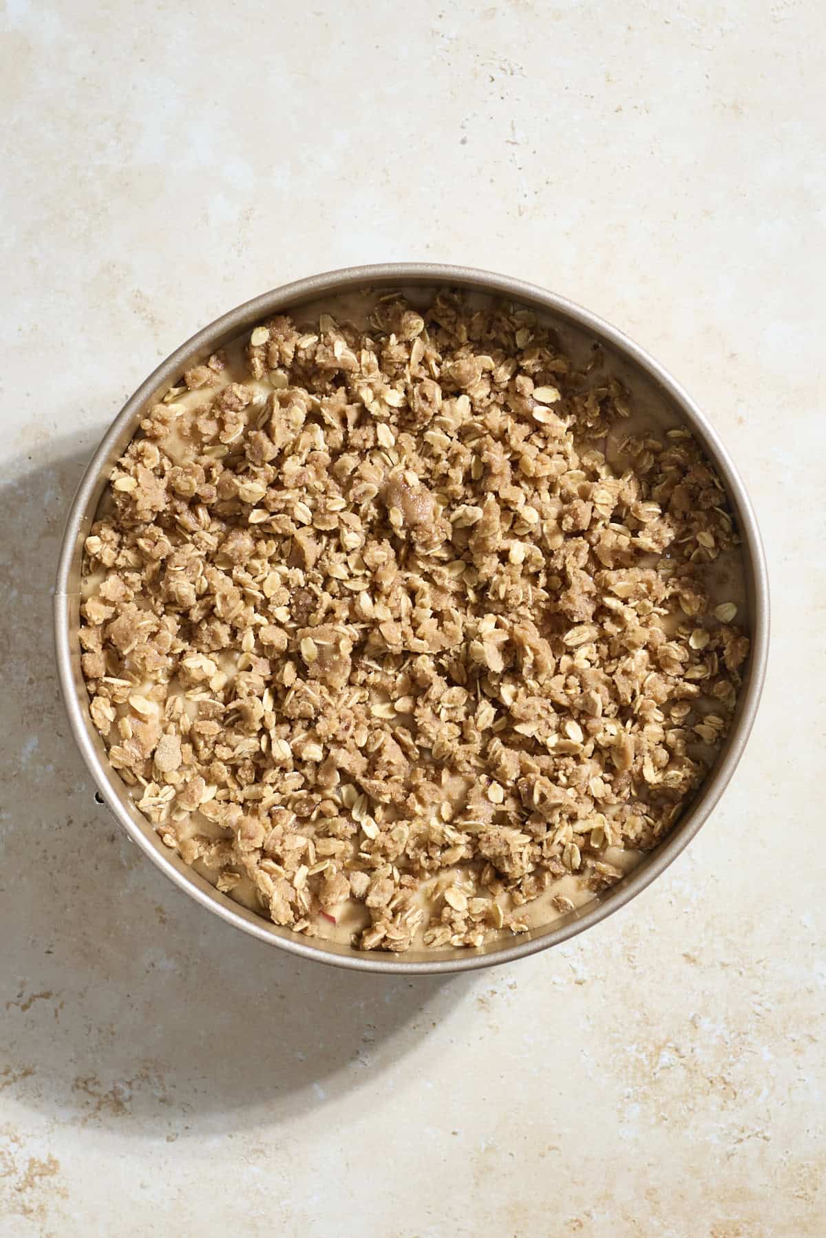 Streusel crumbled on top of the cake batter.
