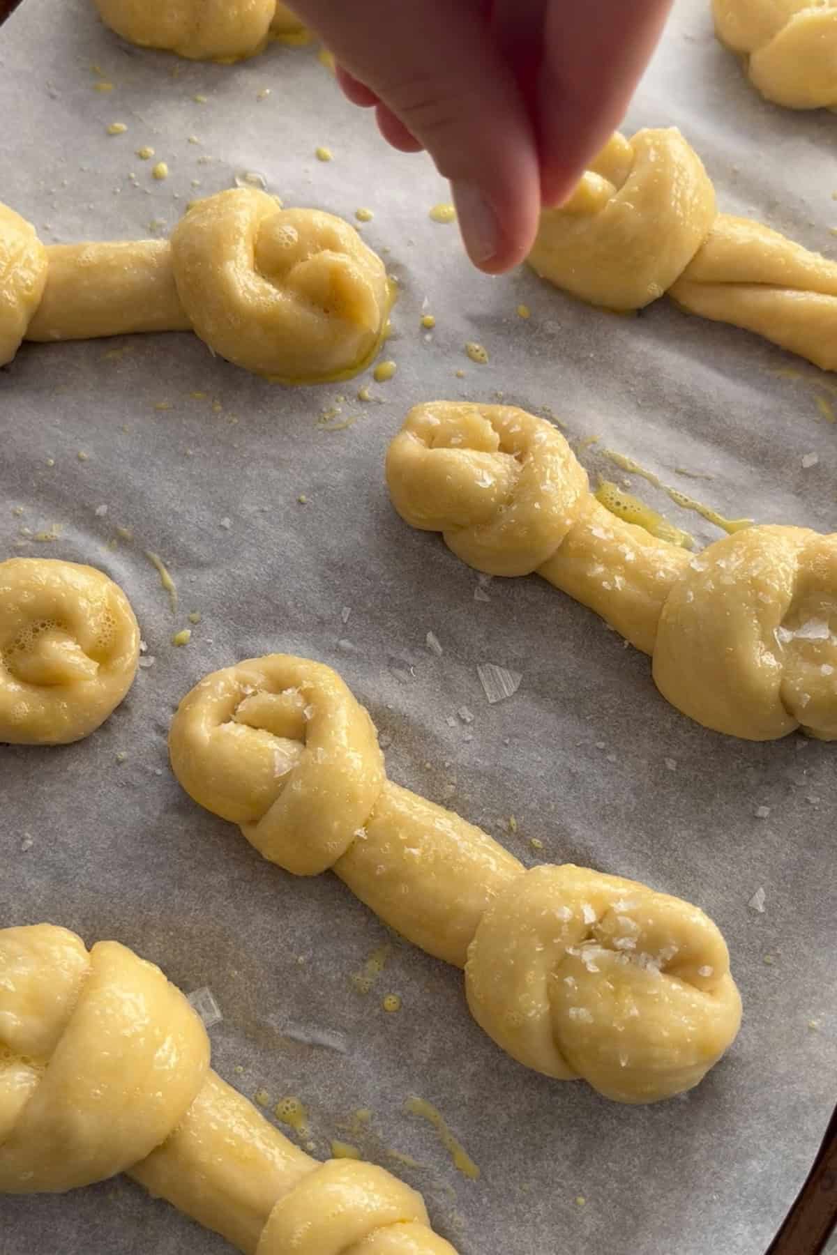 Salt being added to pretzel bones.