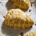 Sourdough Discard Pumpkin Scones with a drizzle of pumpkin glaze.