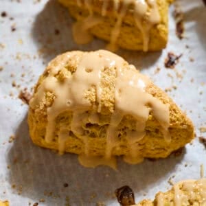 Sourdough Discard Pumpkin Scones with a drizzle of pumpkin glaze.