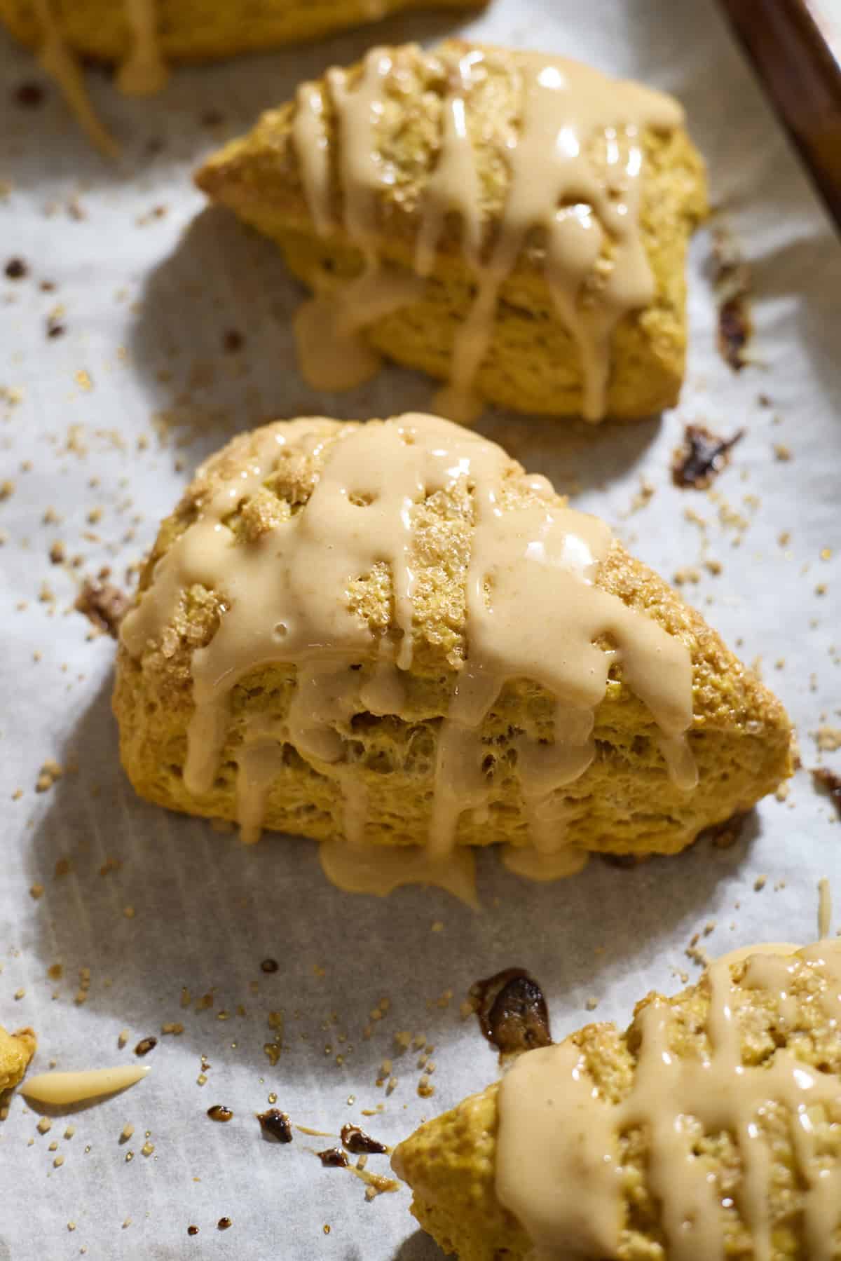 Sourdough Discard Pumpkin Scones with a drizzle of pumpkin glaze.