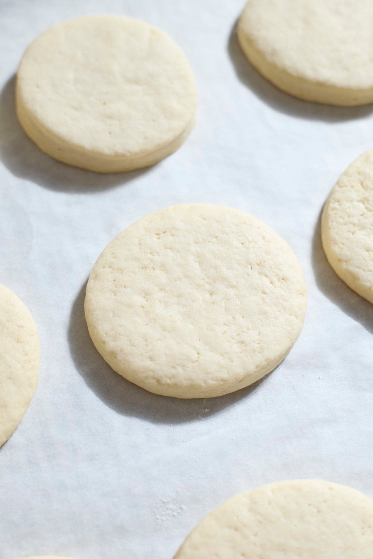 A baked sugar cookie on parchment paper.